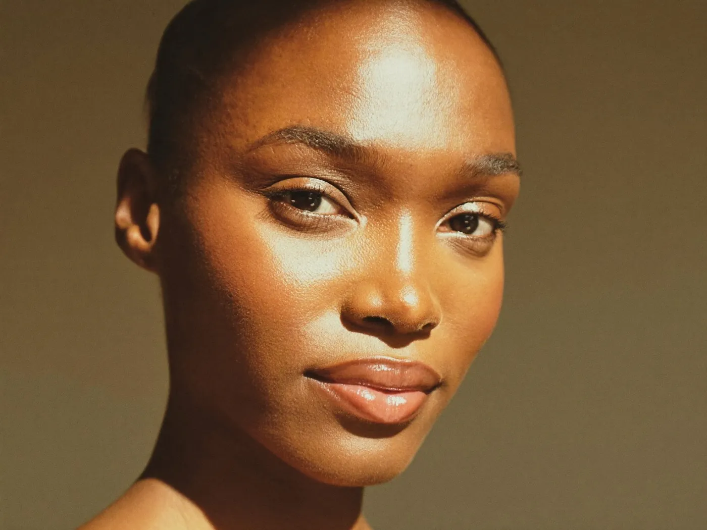 A woman with naturally balanced facial volume in golden light