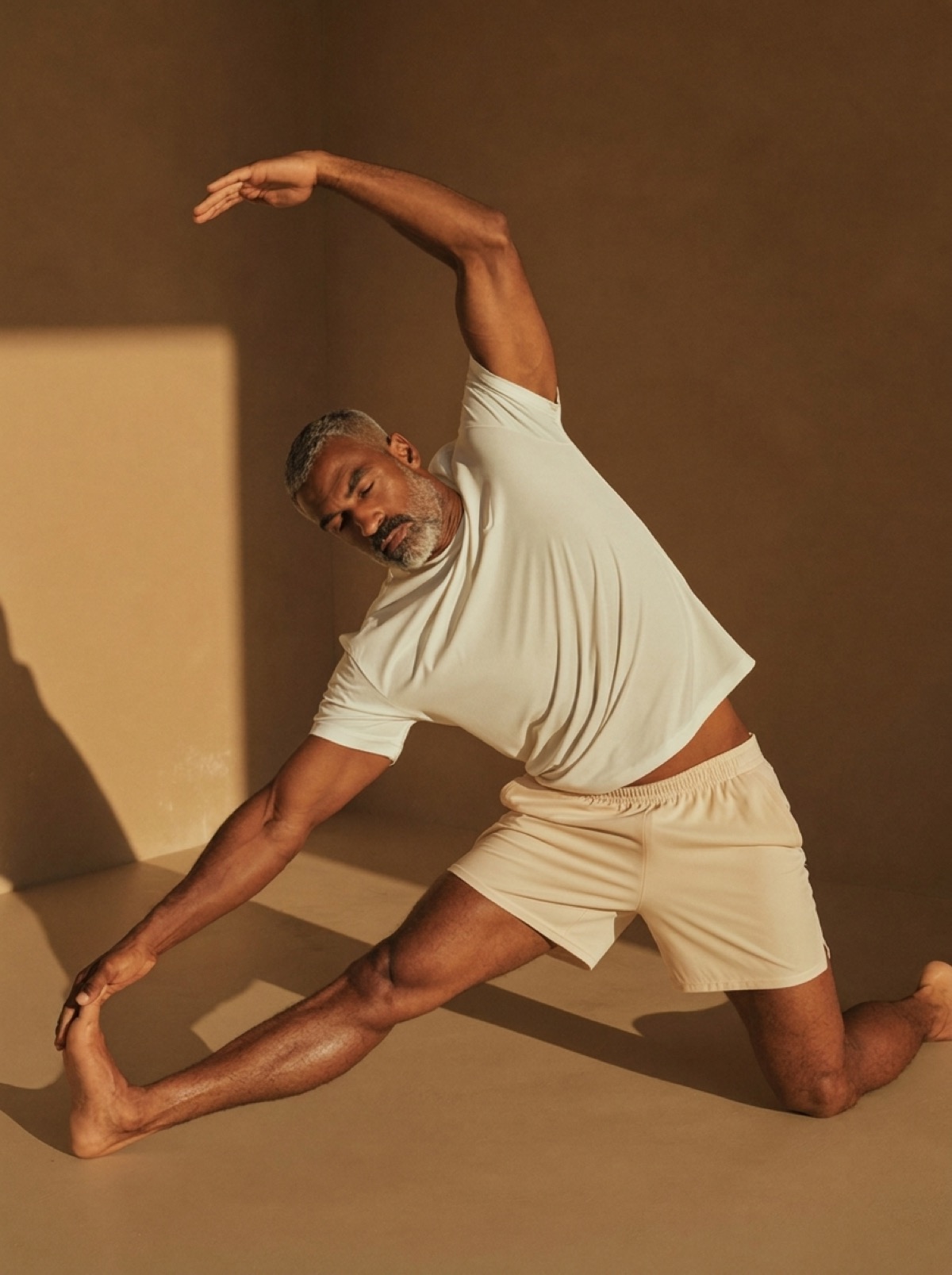 Man stretching with ease in warm morning light